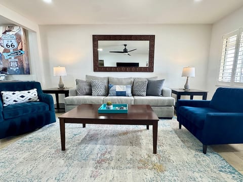 Living Room features plenty of seating including a queen-size sleeper sofa and 75" Smart TV.