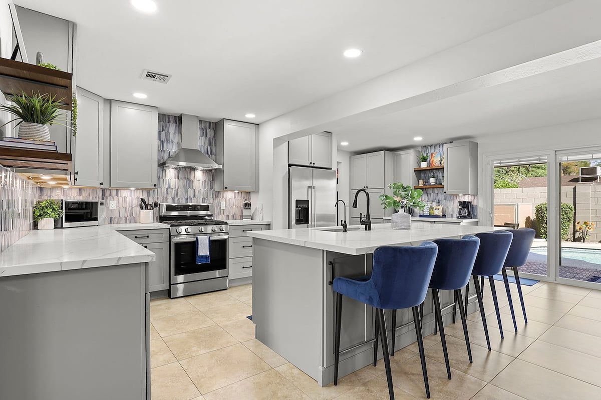 Stunning kitchen renovation just completed, featuring a large island, Quartz countertops, SS Appliances, Beverage Fridge, RO filtered drinking water, Gas Range and fully equipped with all the essentials for cooking & enjoying meals at home!