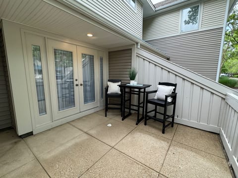 Pub table on front patio, French doors lead into the breakfast nook and kitchen.