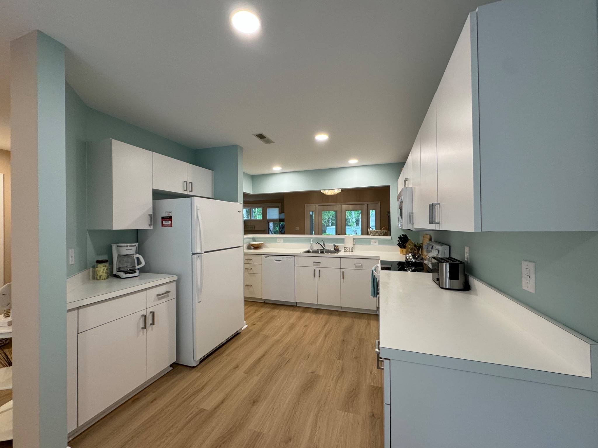 View of kitchen from breakfast nook to dining area. - Serving Sand - Bethany Beach