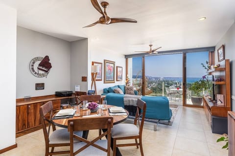Dining area adjacent to living room, with workspace also overlooking the bay