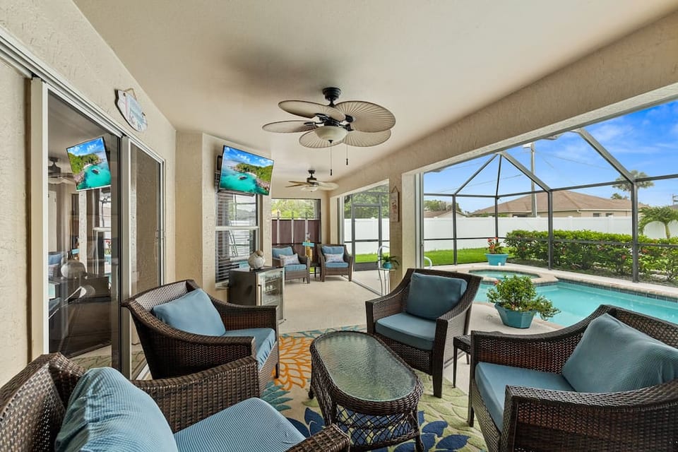 Private outdoor living area with pool, spa, and fully fenced yard. Please note the white fence has been replaced with a chain-link fence and living privacy fence.