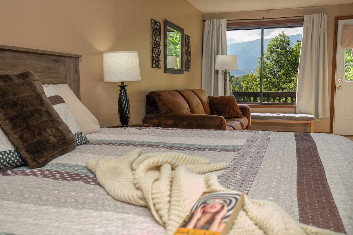 Main level king bedroom w/sleeper sofa & view.