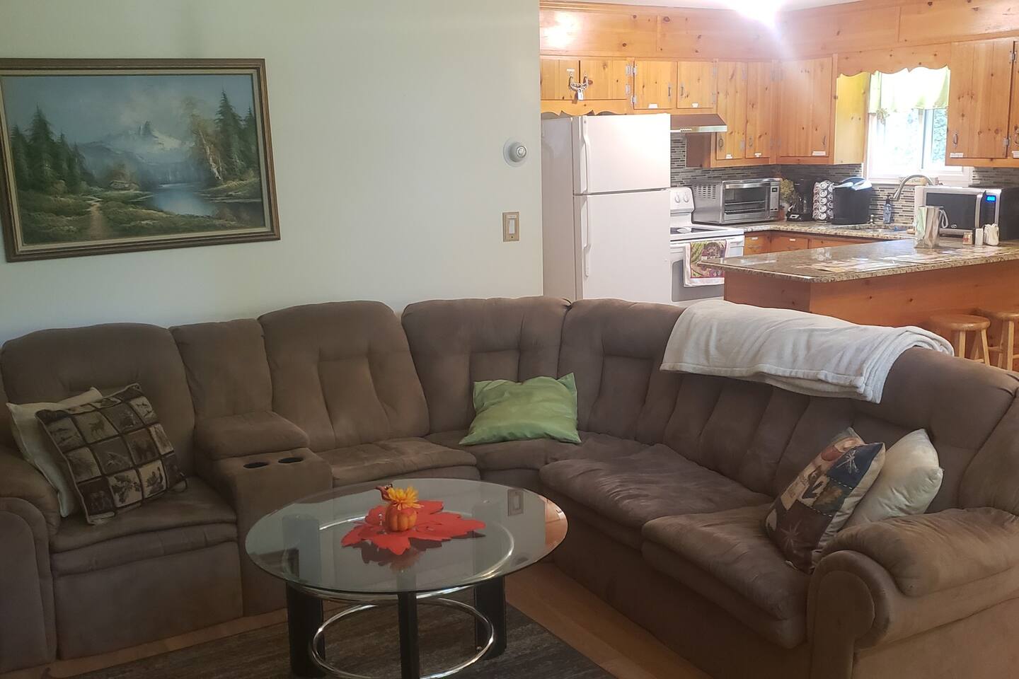 Long wrap around sofa adds a cozy feel while enjoying the fire with friends and family. Couch folds out to a sofa bed. Plenty of extra couch pillows and blankets for comfort.Breakfast bar has bar stools for extra seating in kitchen