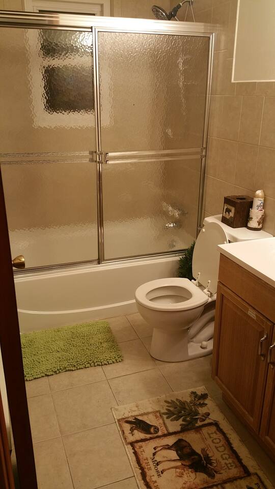 Large themed bathrooms with privacy film on the windows.