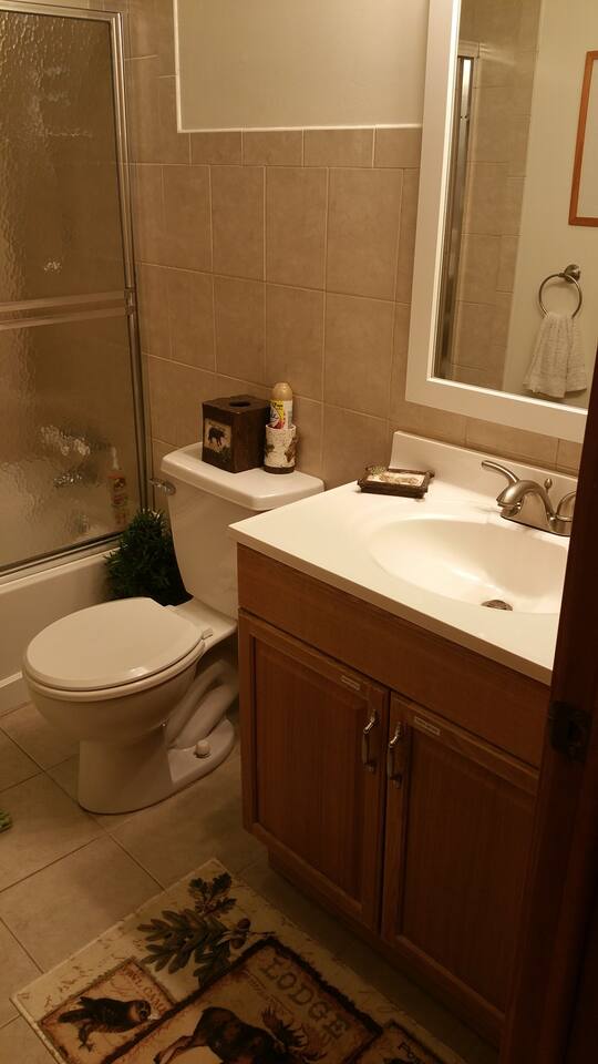 Full bathrooms have large sinks, extra storage, full tubs, showers, with fancy shower heads. Each bathroom sink contains a first aid kit, extra toilet paper, and a hair dryer.