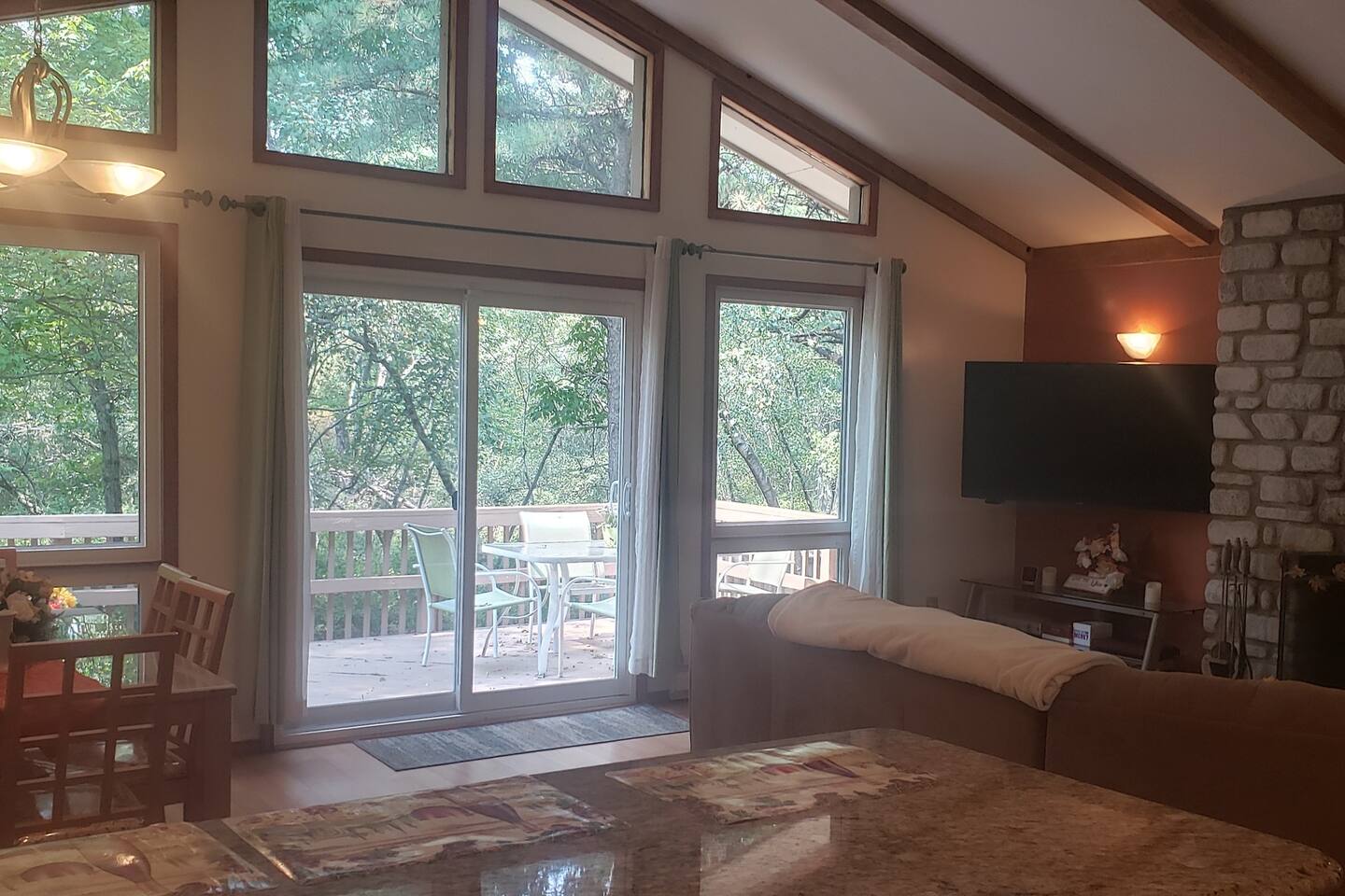 Large open concept kitchen, living room, dining room with vaulted cathedral ceilings and ceiling to floor windows!  Another large fireplace.