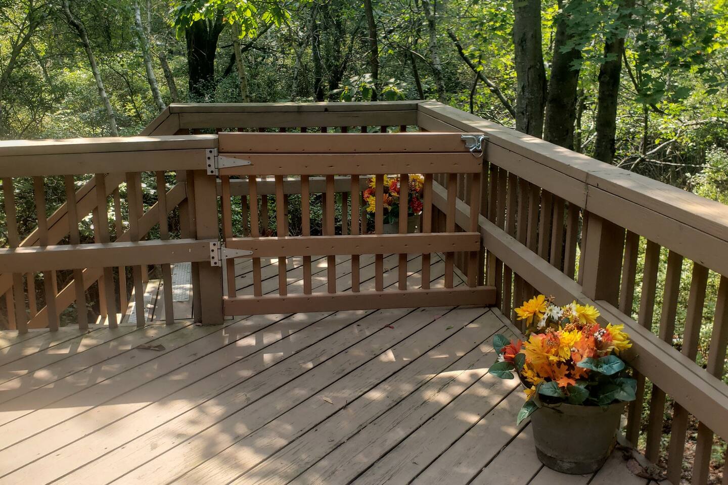 Safety gate on the deck added to help keep children from falling down the stairs and pets from running away. Safety is our main concern so we installed a gate!