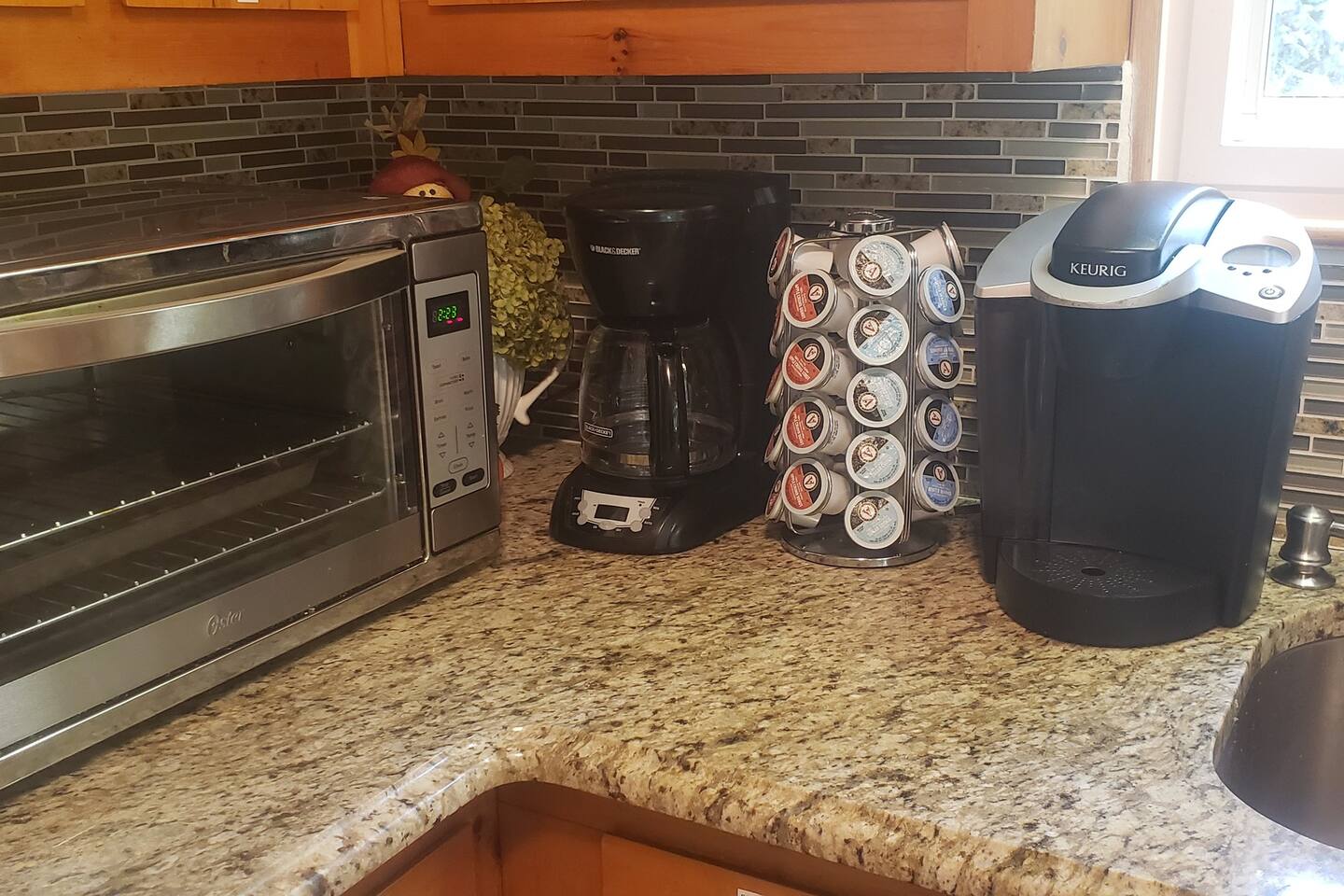 Our coffee station has Complimentary K-Cups of various seasonal flavors. Summers have the Margaritaville flavors! We also have a coffee grinder, pour over coffee maker, and filters.Oooh...is that a convection toaster oven?! :)