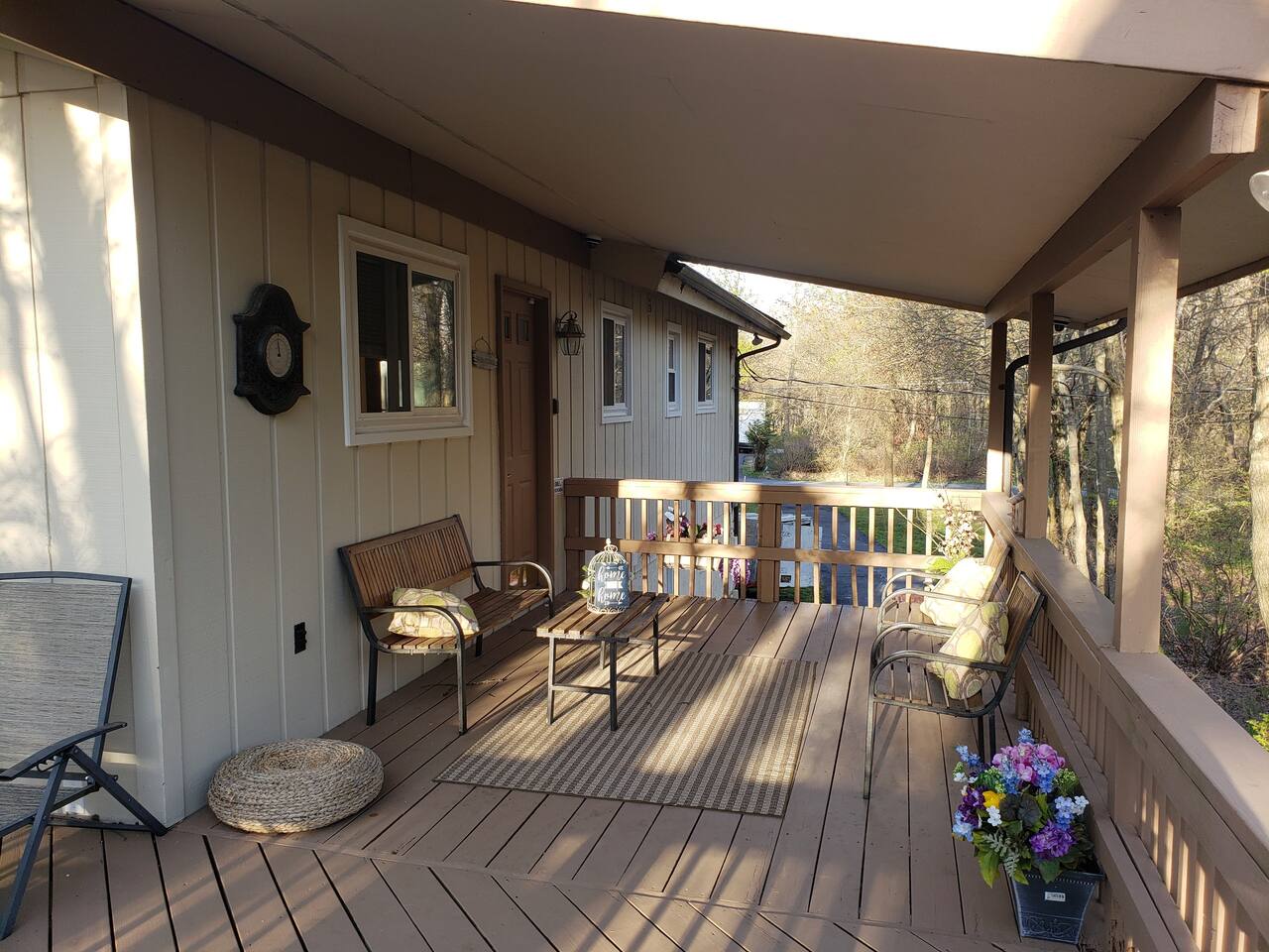 Covered deck perfect for sitting outside during a relaxing rainstorm.