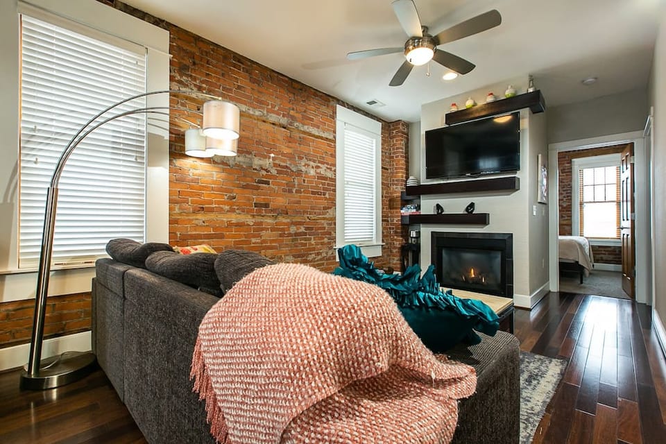 Main living area with gas fireplace, tv and pull out couch.