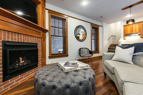 Main floor living area with gas fireplace and large tv
