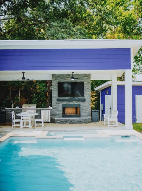Outdoor covered patio and kitchen includes refrigerator and grill + outdoor fireplace with fire wood included.