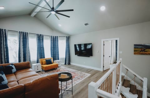 Living room upstairs features a large sectional couch and the yellow chair folds out to a twin size bed.  Perfect for all the kids!