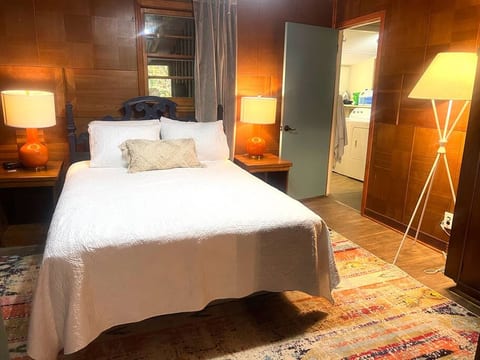 Bedroom 1 - super comfortable queen bed with warm lighting and inviting colors.