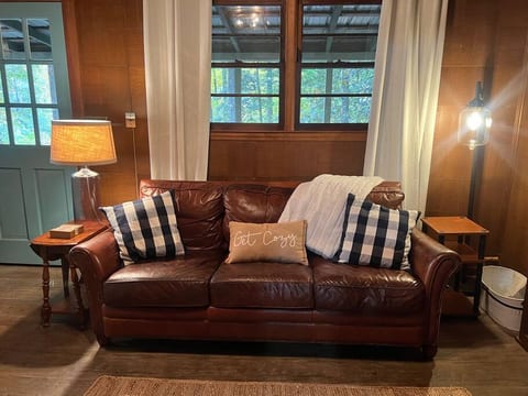 Get Cozy! Living room area with warm lighting and a cozy fur throw for curling up and reading a good book.