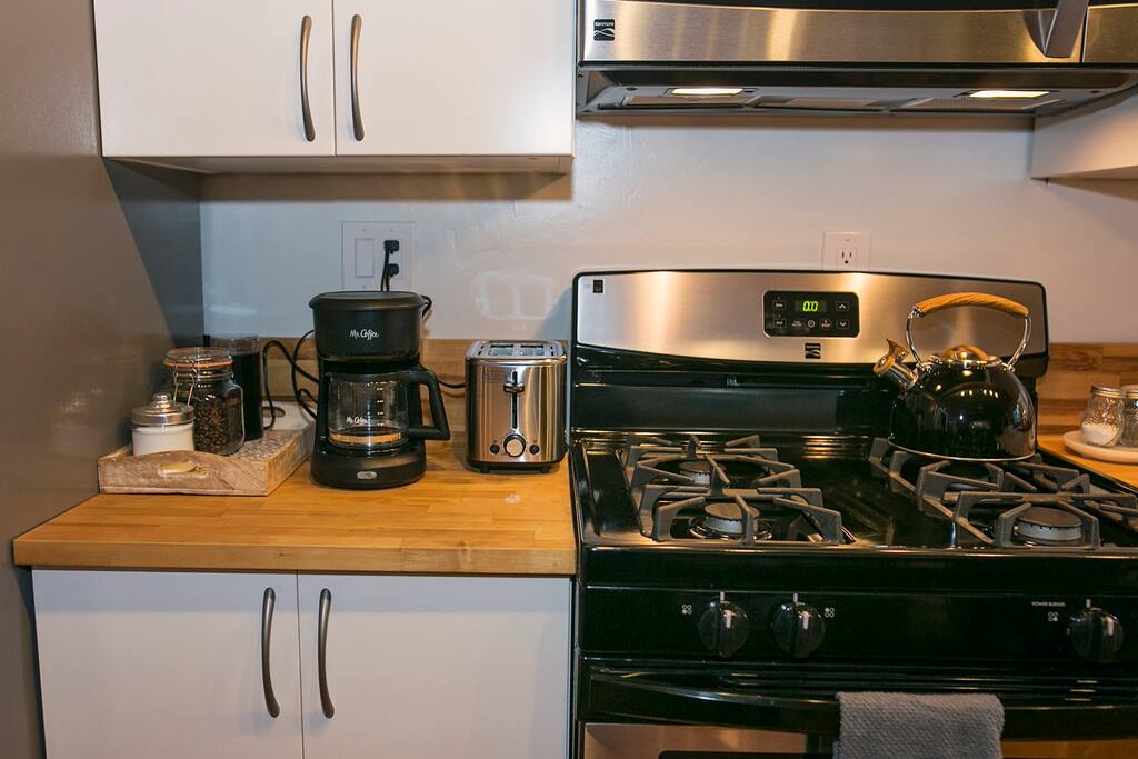 We have a drip coffee machine, coffee grinder, French press, a few variety of teas, sugar, toaster, coffee beans and decaf.