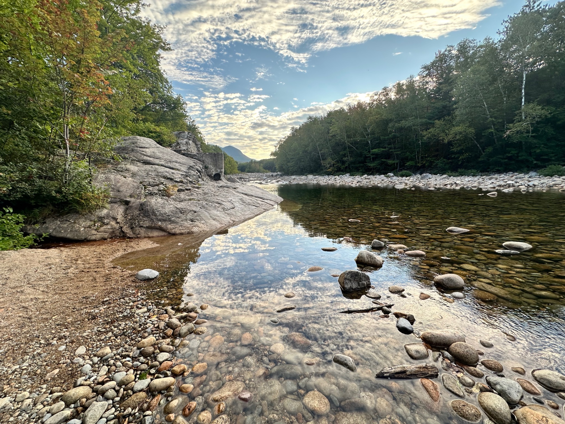 Beach area at swimhole behind home. We love steal away the time with a chair and book down here.