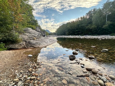 Beach area at swimhole behind home. We love steal away the time with a chair and book down here.