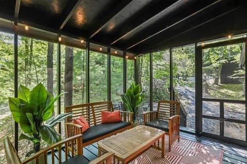 Screened in patio with seating.