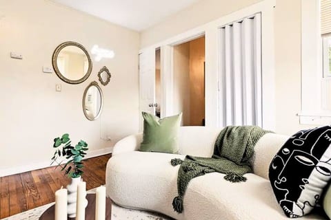 Living room with beautiful white sofa, and green chair