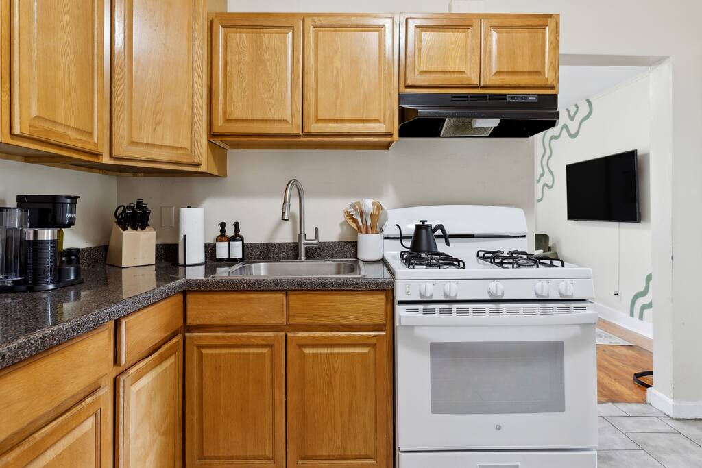 Step into a kitchen where sleek appliances meet contemporary design. The aroma of complimentary coffee fills the air, inviting you to indulge as you explore the state-of-the-art cooking space. - Haven 4 mins from Yale | Fire Pit | Outdoor dining - New Haven