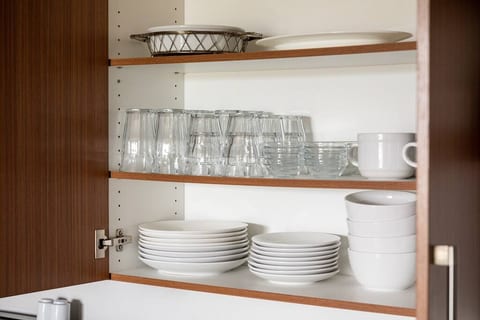 Fully stocked cabinets have all the glassware, plates, and bowls you'll need.
