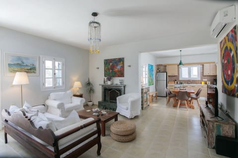 Spacious living room with open plan kitchen and dining table