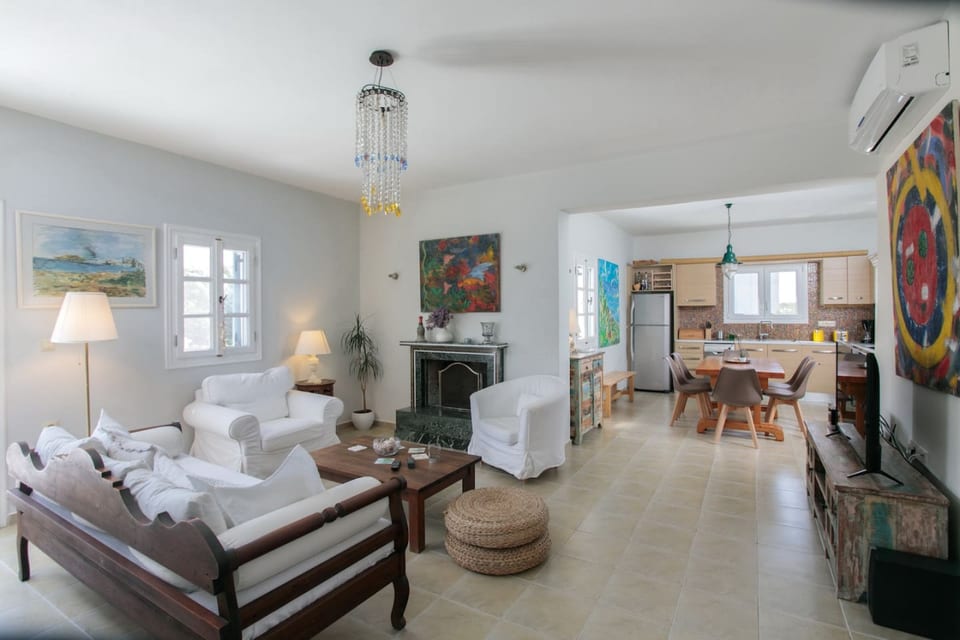 Spacious living room with open plan kitchen and dining table