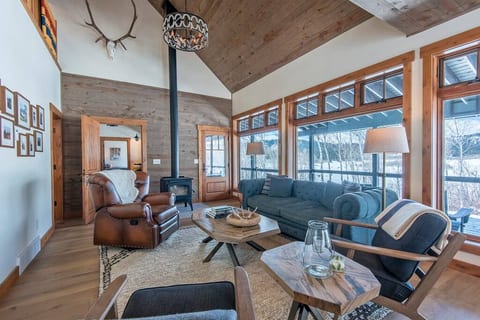 Relax in Tincup Cabin’s living room on comfy seating, including an inviting leather recliner, as you enjoy the warmth of the woodstove.
