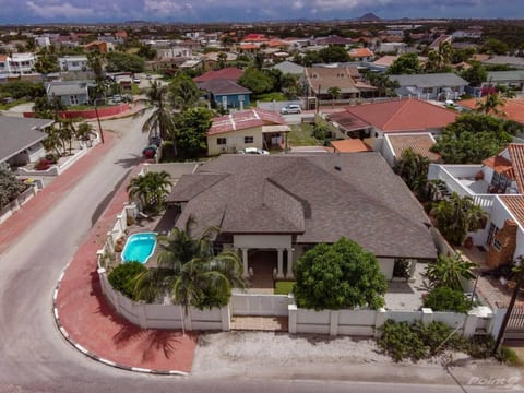 Nestled in a quiet neighborhood, this spacious villa features a private pool, lush greenery, and gated privacy. Just minutes from Eagle Beach, dining, and shopping—your perfect tropical escape awaits!