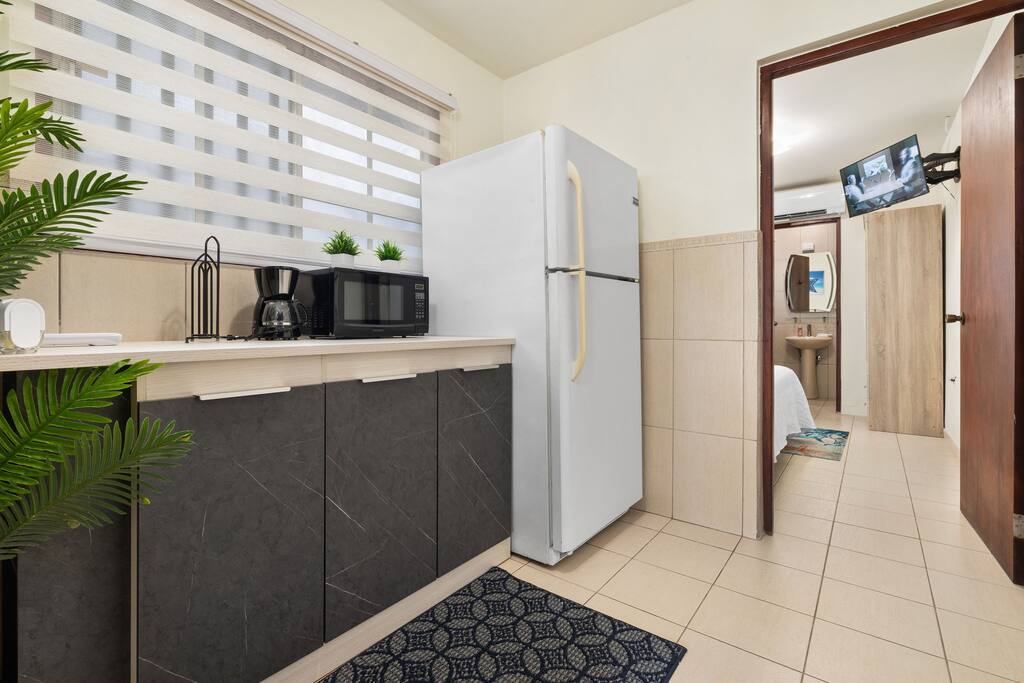 Fully equipped kitchenette in the private casita, featuring a refrigerator, microwave, coffee maker, and modern decor. Your Aruba getaway: private pool + walk to beach