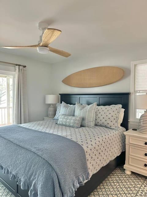Mid-level KING primary bedroom with en-suite bathroom and deck access.