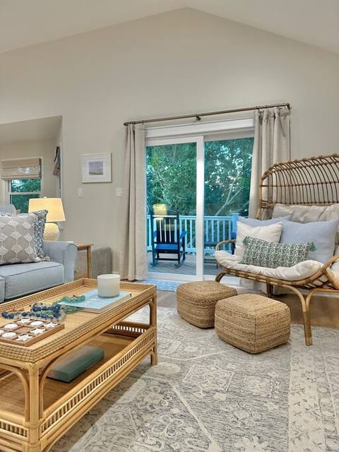 Living room (open to the kitchen) with all new furniture - large sofa, 2 swivel chairs, a large egg chair with stools and a mounted TV with YouTube TV