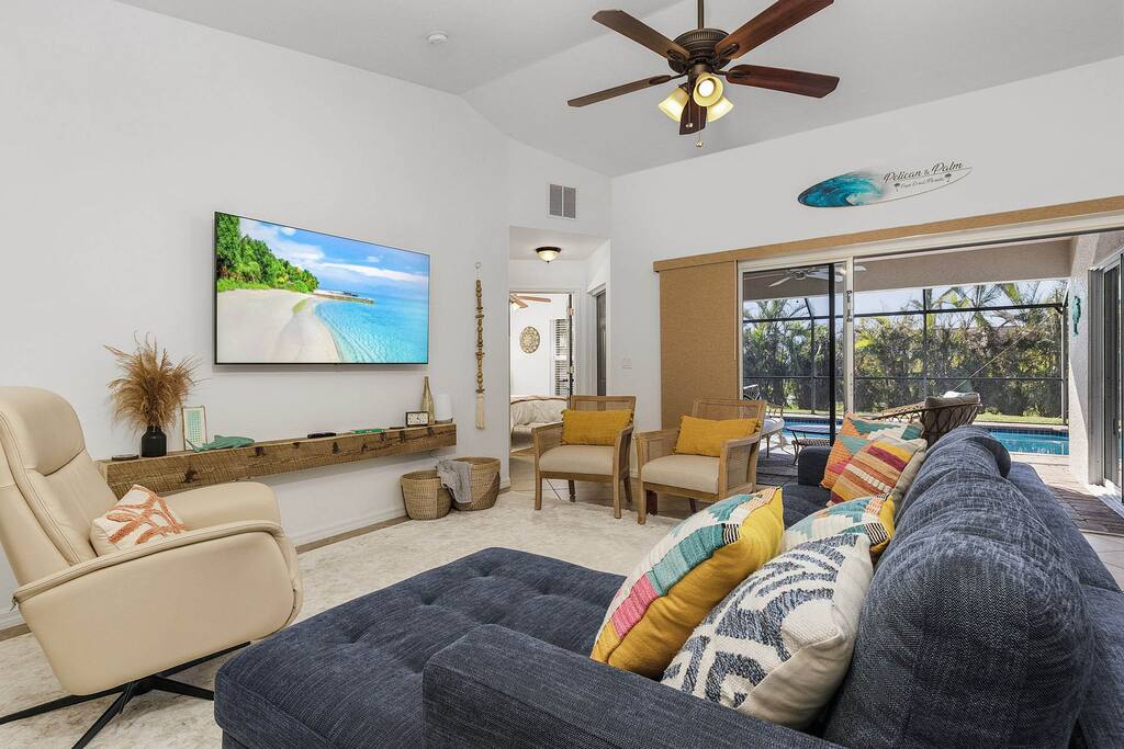 Article sleeper sofa, Hjort Knudsen swivel recliner with cane accent chairs.  Sliders open to the lanai, pool and now our NEW outdoor dining area in the lanai for the '24/'25 season.