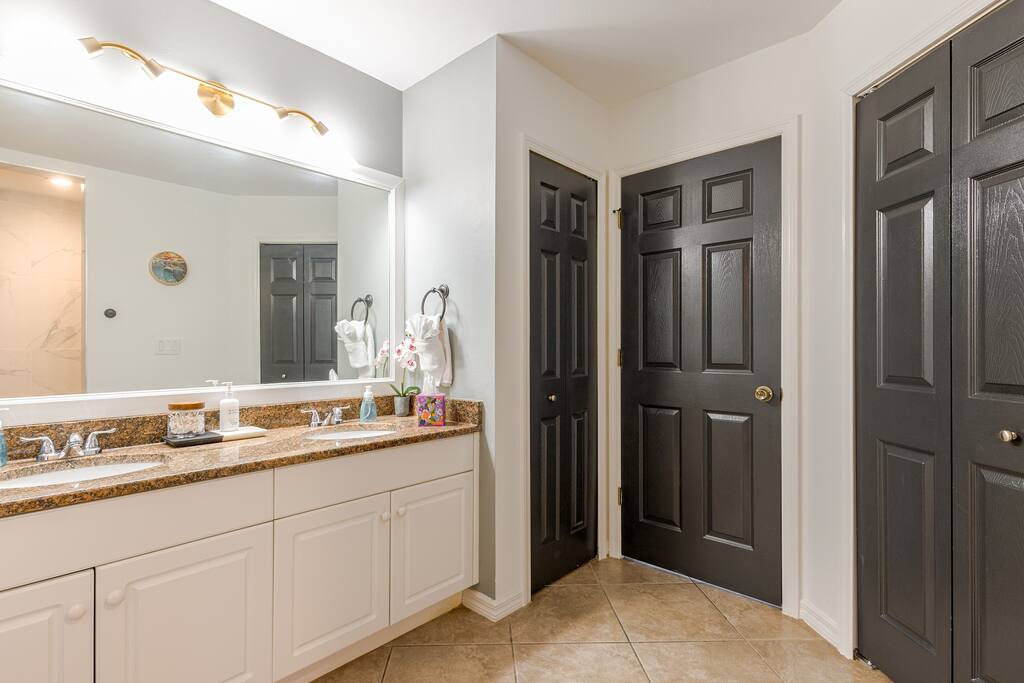 Primary En Suite - guests love the double vanity, the separate and private water closet and all the room the walk-in closet provides for their traveling extras.  A hit with families for sure.