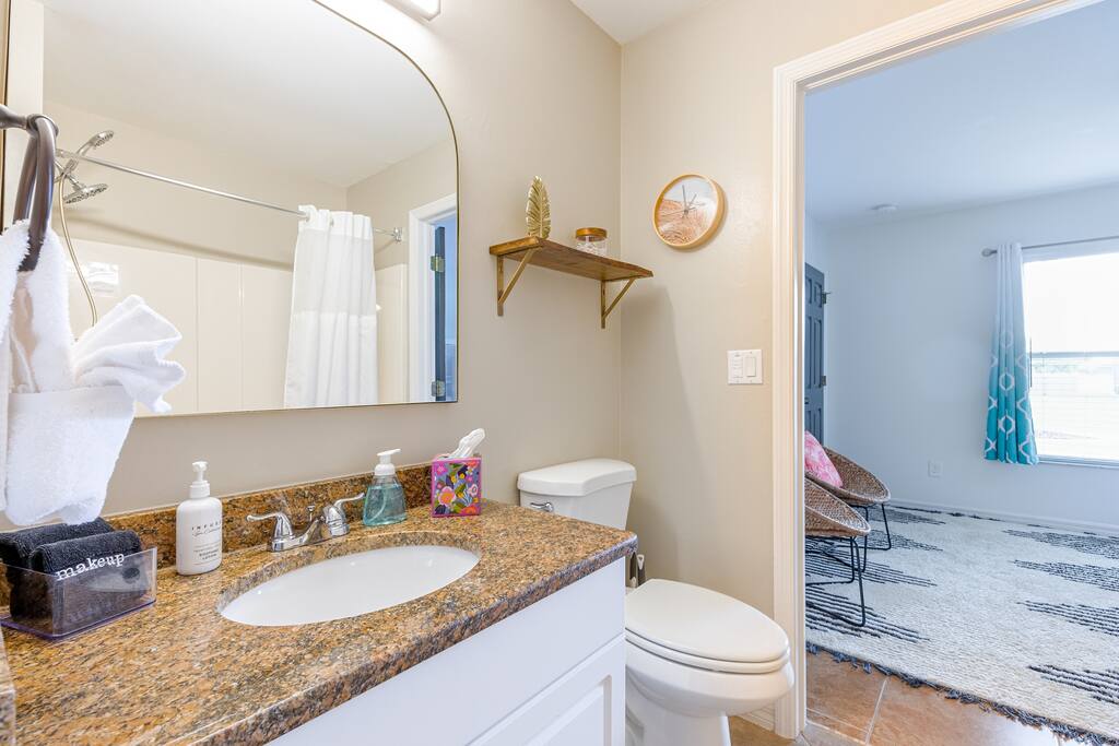 Guest/Pool bath.  Also where we stow our blue & white striped pool towels.  Tub and shower with adjustable shower head and detachable, adjustable shower wand.  You will find premium shampoo, body wash and conditioner - all at the ready.