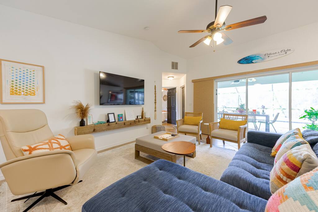 View of the pool and the NEW outdoor dining area in the lanai.  We love opening the front door with each and every visit and seeing this view....straight thru the main living area, the lanai, the pool and the backyard palm hedge.  Love it!
