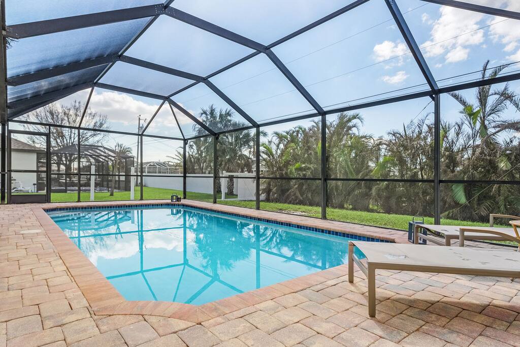 Sun set swim? Private and heated. Outdoor games and a BBQ - not pictured.  Photos were taken days after Hurricane Ian.  Neighbors fence has been restored.  ***we have recently added pop -a- shot and air hockey as well - for more family fun.