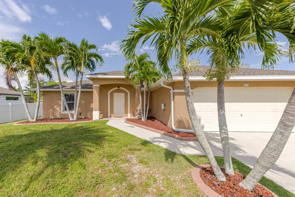 Christmas Palm line each side of the driveway and bookend the entry.  Welcome to Pelican & Palm.