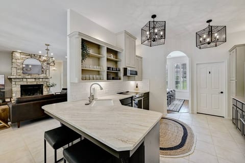 Spacious, fully-equipped kitchen with coffee maker and bar seating.