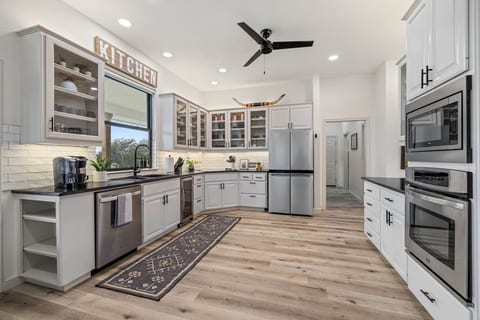 Spacious kitchen fully stocked with all the amenities of home including pots/pans, air fryer, crock pot, etc.
