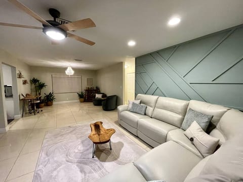 Staying in for the night? Enjoy the spacious living room with your family or friends, relaxing on the luxurious leather couch equipped with 3 recliners.