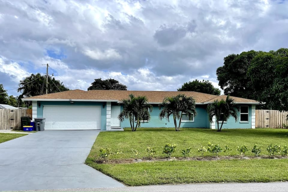 Welcome to your Delray Beach Wanderlust Luxuries Home! Fully fenced in landscaped property, surrounded by beautiful clusias.