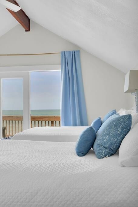 The upstairs Main Suite opens up to a private balcony with panoramic Atlantic Ocean views. Blackout curtains, Dechateaux real wood wide plank floors. The other side of the room welcomes you with a spa like bathroom.
Two Queen Beds set up like a hotel room.