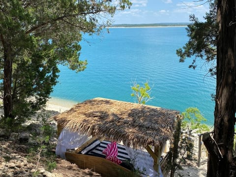 Lakeside cabana with daybed and a view.