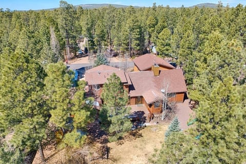 The home is surrounded by majestic pine trees and located close to parks, golf courts, and a ski resort.