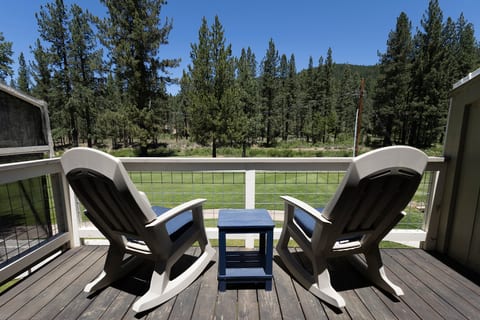 Relax on the private deck with rocking chairs and peaceful forest views