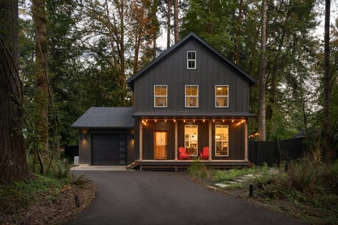 As the sun sets, the porch lights glow — your Rhododendron cabin welcomes you home.