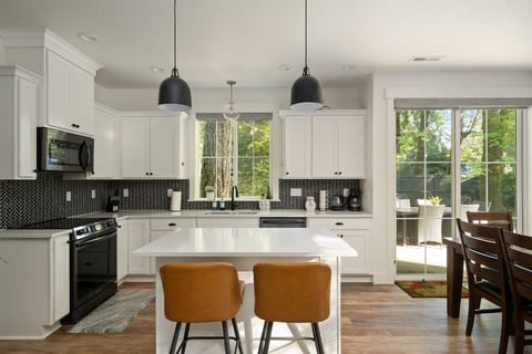 A fully stocked kitchen with island seating, ready for home-cooked meals.
